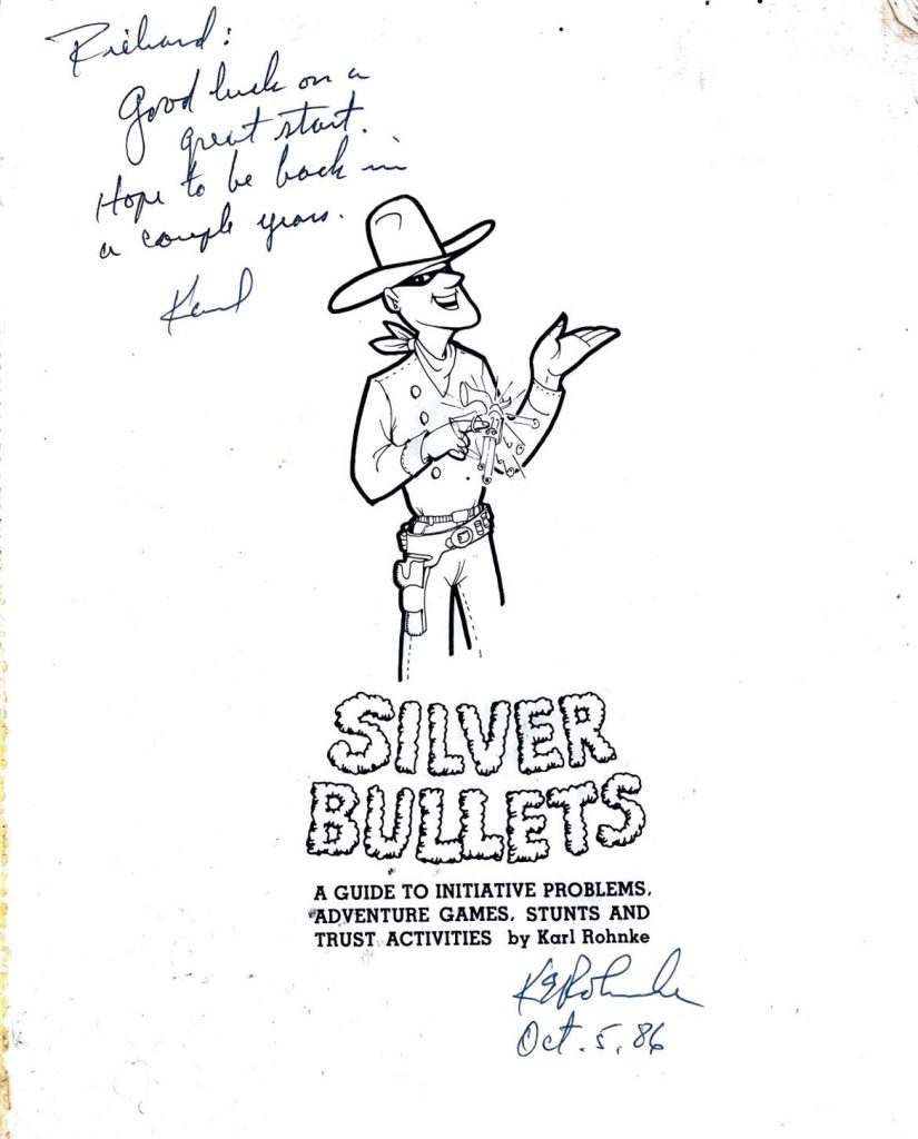 Signed book cover by Karl Rhonke titled "Silver Bullets: A guide to iniative problems adventure games, stunts and trust activities."