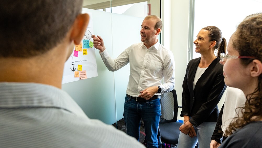 Angus showing a team how to develop a team charter